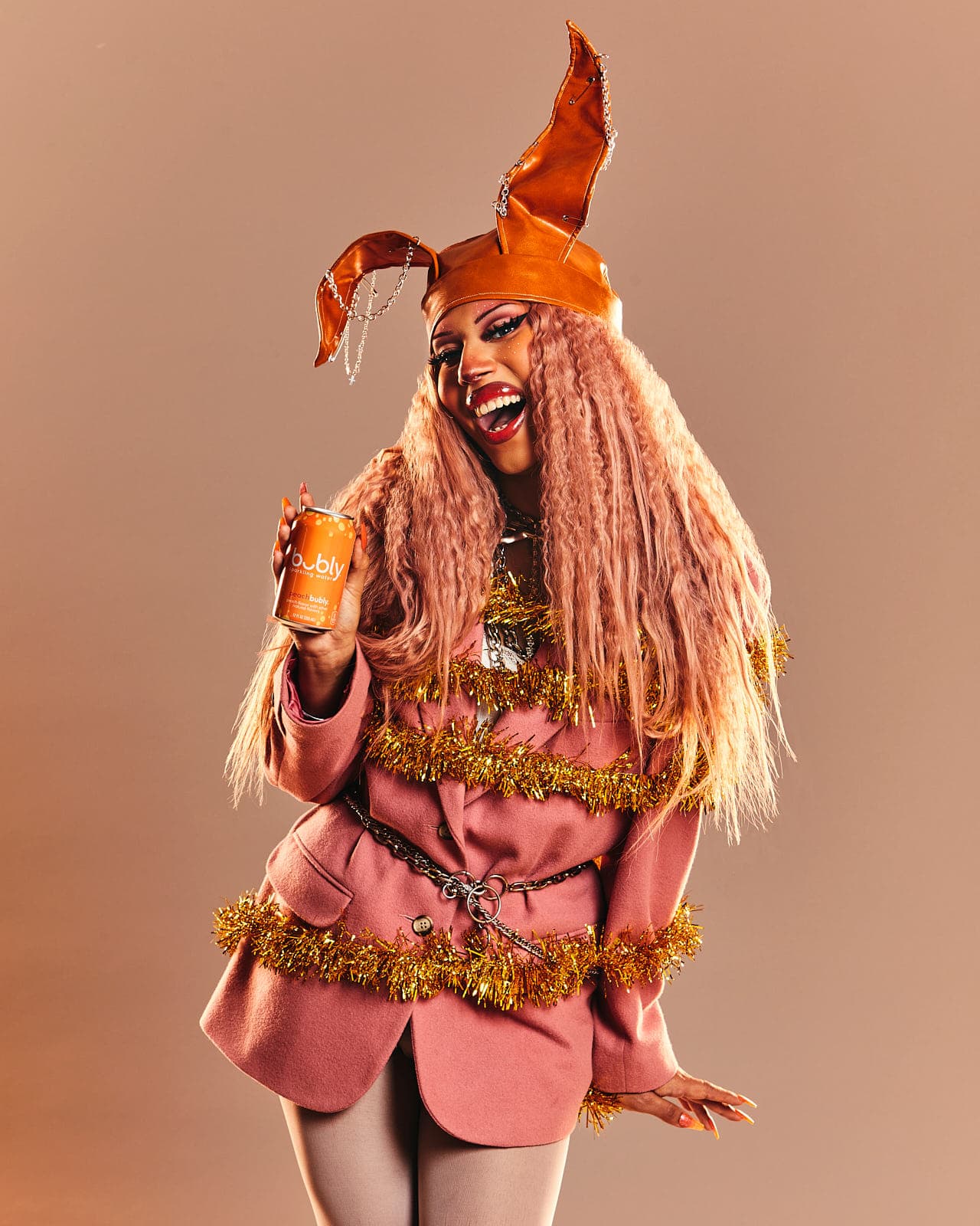 drag queen holding can of bubly water